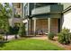 Charming covered patio with brick wall, seating, and manicured lawn offers a relaxing outdoor space at 77 Delmont Ne Dr, Atlanta, GA 30305