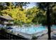 Community pool with families swimming and lots of lounge chairs surrounding it at 77 Delmont Ne Dr, Atlanta, GA 30305