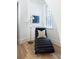Cozy reading nook with hardwood floors, natural light, stylish chaise lounge, and modern decor at 77 Delmont Ne Dr, Atlanta, GA 30305