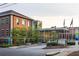 School exterior showcasing a blend of brick architecture and modern glass design, along with landscaped grounds at 77 Delmont Ne Dr, Atlanta, GA 30305