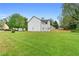 Lush green backyard showcases the home's white siding, dark roof, and well-maintained lawn at 1125 Reunion Pl, Atlanta, GA 30331