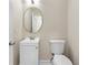A compact half-bathroom with a stylish mirror, vanity, and toilet at 1125 Reunion Pl, Atlanta, GA 30331