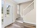 Light-filled entryway with glass door, staircase, and wood-look flooring at 1125 Reunion Pl, Atlanta, GA 30331