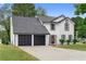 A charming two-story home has a well-manicured lawn and a two-car garage at 1125 Reunion Pl, Atlanta, GA 30331
