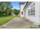Concrete patio offers an outdoor living space adjacent to the home's back facade and manicured lawn at 1125 Reunion Pl, Atlanta, GA 30331