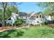 Spacious backyard with lush green grass, landscaping, and a view of the home's exterior at 1991 River Forest Dr, Marietta, GA 30068