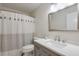 Well-lit bathroom with a shower featuring a stylish curtain and a vanity with a white countertop at 1991 River Forest Dr, Marietta, GA 30068
