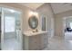 Bathroom featuring marble floors, gray cabinets and a vanity with doorways to the laundry and bedroom at 1991 River Forest Dr, Marietta, GA 30068