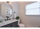 Well-lit powder room features a marble countertop vanity, modern fixtures, and a decorative mirror at 1991 River Forest Dr, Marietta, GA 30068