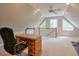 Bonus room with built in desk and staircase overlooking the area. Natural light through the triangular windows at 1991 River Forest Dr, Marietta, GA 30068