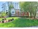Charming brick home with mature trees, manicured lawn and a beautifully landscaped front yard at 1991 River Forest Dr, Marietta, GA 30068