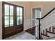 Inviting foyer with hardwood floors, glass paned front door, and a staircase at 1991 River Forest Dr, Marietta, GA 30068