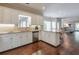 Open kitchen with white cabinets, stainless steel appliances, and hardwood floors at 1991 River Forest Dr, Marietta, GA 30068
