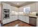 Well-lit kitchen featuring stainless steel appliances, granite countertops, and hardwood floors at 1991 River Forest Dr, Marietta, GA 30068