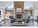 Bright living room with a floor to ceiling stone fireplace, vaulted ceilings, and custom built-ins at 1991 River Forest Dr, Marietta, GA 30068