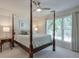 Bright main bedroom featuring a four-poster bed, ceiling fan and large windows at 1991 River Forest Dr, Marietta, GA 30068