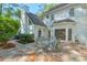Charming patio with stone flooring, an outdoor dining set, and a view of the home's exterior at 1991 River Forest Dr, Marietta, GA 30068