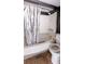 Bathroom featuring a tub with shower, tiled floor, and white toilet at 4964 N Ellipse Dr, Marietta, GA 30068