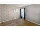 Bedroom featuring a textured brick accent wall, window with curtains, and neutral carpet at 4964 N Ellipse Dr, Marietta, GA 30068
