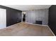 Bedroom featuring dark walls and a brick accent wall with a view into another room at 4964 N Ellipse Dr, Marietta, GA 30068