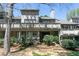 Back exterior of a gray home with a deck and brown plants around it at 4964 N Ellipse Dr, Marietta, GA 30068