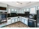 Kitchen featuring vintage appliances, bright cabinets, and black backsplash at 4964 N Ellipse Dr, Marietta, GA 30068
