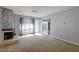 Cozy living room featuring a stone fireplace, plush carpet, and natural light at 4964 N Ellipse Dr, Marietta, GA 30068