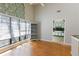 Living room featuring wood floors, built-in shelving, and access to the kitchen at 4964 N Ellipse Dr, Marietta, GA 30068