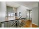 Bright upstairs area with wood floors, white railing, and access to a bathroom at 4964 N Ellipse Dr, Marietta, GA 30068