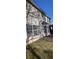 View of the side of the house with windows, a door, and green grass in the backyard at 3247 Sugar Creek Se Trce, Atlanta, GA 30316