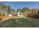 Fenced backyard featuring a screened porch, patio, and a lush lawn surrounded by mature trees at 460 Haynes Creek Circle, Oxford, GA 30054