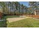 Large, fenced backyard with a patio area, perfect for outdoor dining and entertaining with natural surrounding at 460 Haynes Creek Circle, Oxford, GA 30054