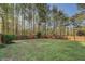 Well-maintained backyard with a wooden fence offering privacy and defined landscaping at 460 Haynes Creek Circle, Oxford, GA 30054