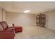 Finished basement area with tile flooring, red leather sofa, and decorative privacy screen at 460 Haynes Creek Circle, Oxford, GA 30054