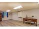 Finished basement space features wood-look flooring, a vintage desk, and a small window at 460 Haynes Creek Circle, Oxford, GA 30054