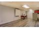 Finished basement with wood-look flooring, a vintage desk, and ample lighting at 460 Haynes Creek Circle, Oxford, GA 30054