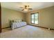 Inviting bedroom with a metal daybed, large window, and neutral carpet flooring at 460 Haynes Creek Circle, Oxford, GA 30054