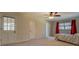 Bright bedroom featuring a ceiling fan, beige carpet, and access door to an outdoor porch at 460 Haynes Creek Circle, Oxford, GA 30054