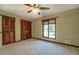Cozy bedroom with ceiling fan, window, and a spacious closet, perfect for storage at 460 Haynes Creek Circle, Oxford, GA 30054