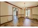 Dining room with decorative trim, large windows, and a chandelier above the round table at 460 Haynes Creek Circle, Oxford, GA 30054