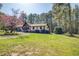 Attractive home with a sprawling front lawn and mature trees providing shade at 460 Haynes Creek Circle, Oxford, GA 30054