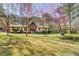 Inviting one-story home featuring a well-manicured lawn and blossoming trees in a serene setting at 460 Haynes Creek Circle, Oxford, GA 30054
