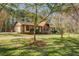Charming one-story house with stone and siding exterior, set on a lush green lawn with mature trees at 460 Haynes Creek Circle, Oxford, GA 30054