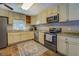 Well-lit kitchen features granite countertops, stainless steel appliances, and ample cabinet space at 460 Haynes Creek Circle, Oxford, GA 30054