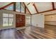 Open living area featuring vaulted ceilings, hardwood floors, and a grand entryway at 460 Haynes Creek Circle, Oxford, GA 30054