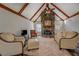 Cozy living room showcasing a stone fireplace, vaulted ceilings, and comfortable seating at 460 Haynes Creek Circle, Oxford, GA 30054