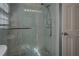 Contemporary shower featuring clear glass enclosure, rain shower head, and mosaic-tiled floor at 460 Haynes Creek Circle, Oxford, GA 30054