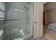 Modern shower with glass door, white tile, and mosaic-style floor, located in the bathroom at 460 Haynes Creek Circle, Oxford, GA 30054