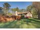 Picturesque home featuring wood fence, lush garden beds, and a well-maintained lawn at 460 Haynes Creek Circle, Oxford, GA 30054