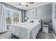 Charming bedroom featuring plush carpet, a ceiling fan, natural light, and calming neutral wall paint at 5462 S Crest Ridge S Dr, Ellenwood, GA 30294